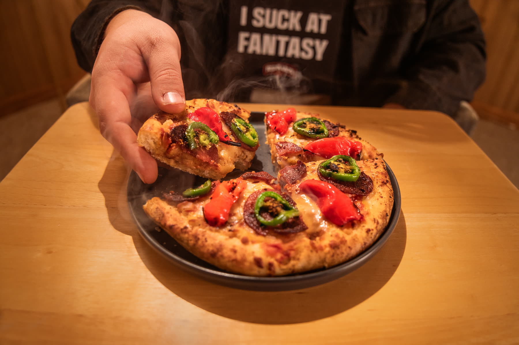 Humble Pie slice with the I SUCK AT FANTASY bib